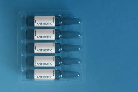 Antibiotics using concept. Five ampules with overlay letters of inscription A 库存照片