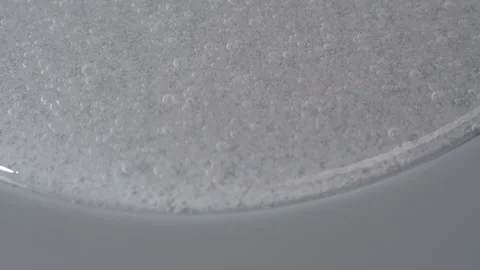 Anticeptic hand gel close-up. Liquid soap texture on grey background. Skincare Stock Footage 178610840