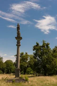 Anticue column with statue up the top Stock Photos