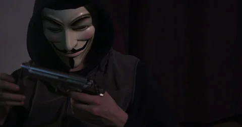Antifa terrorist cleaning gun ready to incite violence at a rally Stock Footage 34394080