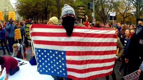 Antifa with an upside down American flag 库存影片 73231422