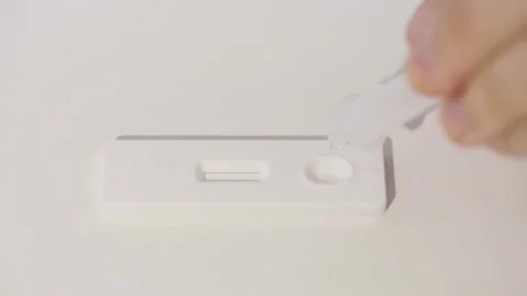 Antigen test cassette, rapid covid-19 test with drops of reagent liquid. Stock Footage 170844288