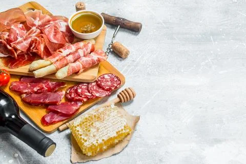 Antipasto background.Assortment of meat snacks with red wine. Stock Photos