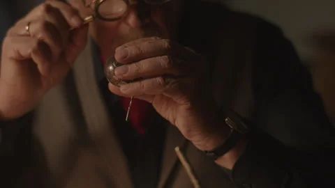 An Antiquarian checking a skull item using the magnifier Stock Footage 258297532