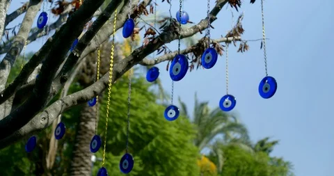Antique amulets nazars using to ward off the evil eye in yard of house, hanging Stock Footage 115917777