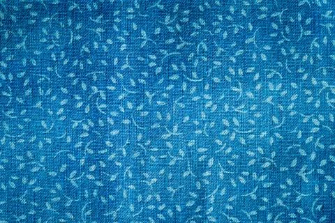 Antique blue fabric with vining pattern Stock Photos