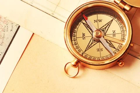 Antique brass compass over old map Stock Photos