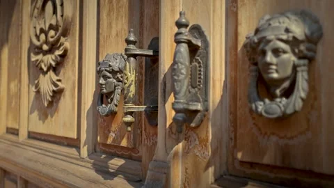 Antique Brass Door Knocker With Classical Face Motif On Weathered Wooden Doo Stock Footage 342354354