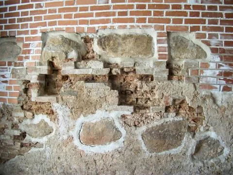 Antique bricks and stones in the castle wall. Stock Photos