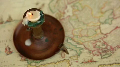 Antique Candle Burning On Old World Map Stock Footage 80773856