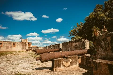 Antique cannons with traces of rust lined up to defend fort. Iron cannons Stock Photos