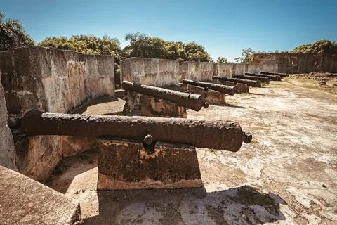 Antique cannons with traces of rust lined defend fortress in Dominican Republ Stock Photos