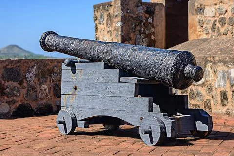 Antique cannons with traces of rust lined up to defend fort. Iron cannons Stock Photos