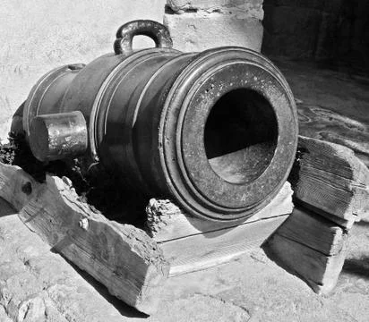 Antique cast-iron cannon that served for coastal defense in the Moroccan city Stock Photos