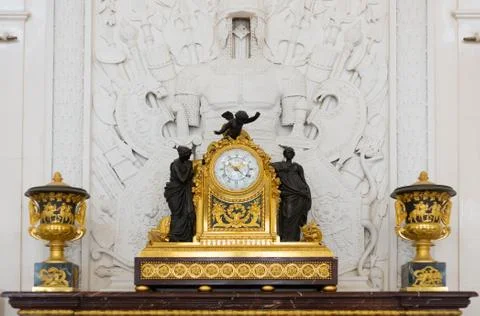 Antique clock in gold case in the interior hermitage museum Stock Photos