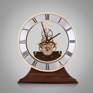 Antique clock  on grey background. Stock Photos