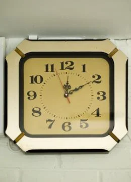ANTIQUE CLOCK MOUNTED ON WALL Stock Photos