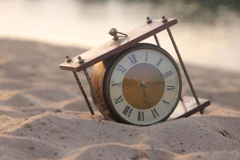 Antique clock in the sand Stock Photos