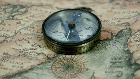 Antique compass on ancient map. Old vintage retro compass on ancient map ba.. Stock Footage 257872837