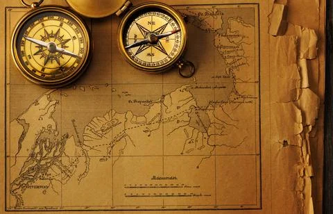 Antique compass over old map Antique brass compass over old map Copyright:... Stock Photos
