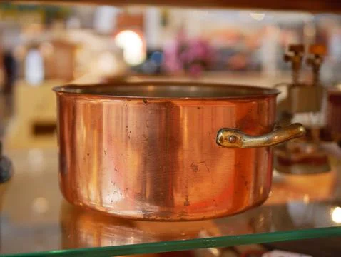 Antique copper cookware kitchen pot with brass handles Stock Photos