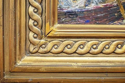 Antique gilded frame corner with decorative braided relief Stock Photos
