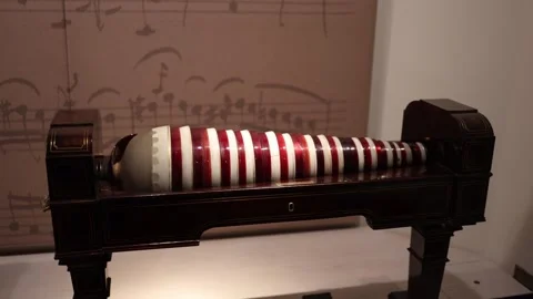 An antique glass harmonica displayed in a museum, featuring its elegant striped  Stock Footage 293565741