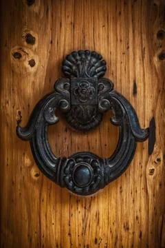 Antique handle of a solid wood door. Stock Photos