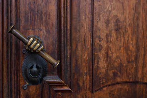 Antique italian rust brown door handle with scroll in hand Photos