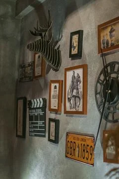 Antique items on the grey stone wall. Coffee shop interior. Stock Photos