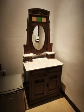 Antique Javanese dressing table with oval mirror and marble top Stock Photos
