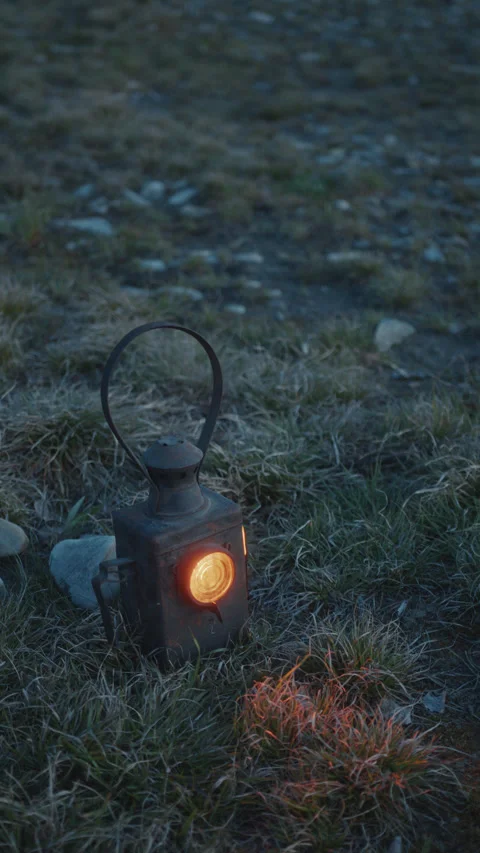 Antique Lantern with Glowing Light Placed on Grass at Twilight Stock Footage 297822109