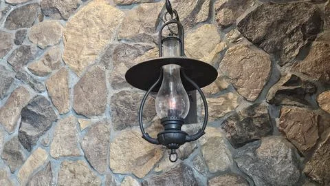 Antique Lantern Hanging on Rustic Stone Wall Stock Photos