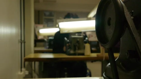 Antique leather sewing machine. Close up with worker in the Background Stock Footage 274415923