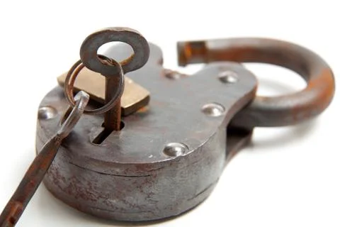 Antique lock with skeleton key on white Stock Photos