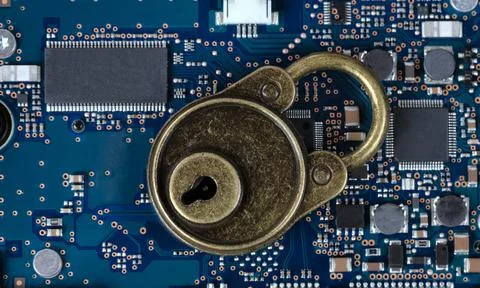 Antique lock on top of computer circuit board for securing technology Stock Photos