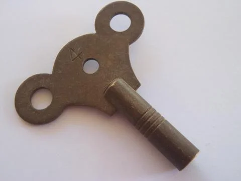 Antique old fashioned clock key Stock Photos