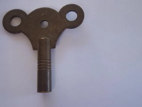 Antique old fashioned clock key Stock Photos