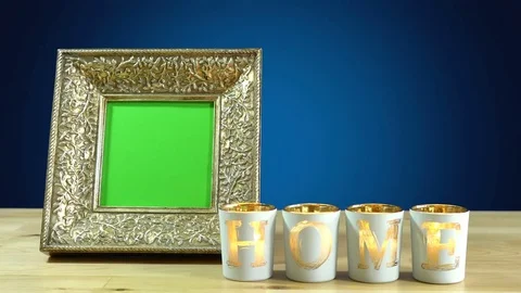 Antique photo frame with green screen and burning home candles in elegant tab Stock Footage
