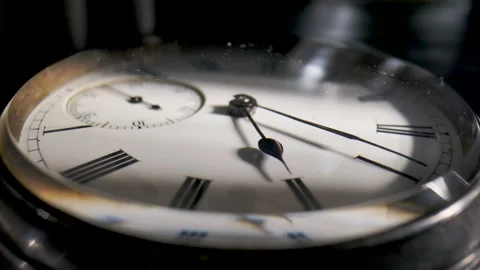 Antique pocket watch with a shadow on the dial and rotating hands in time lapse Stock Footage 203886536