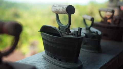 Antique rusty charcoal iron for ironing clothes with wooden handle stands o.. Stock Footage 304472934