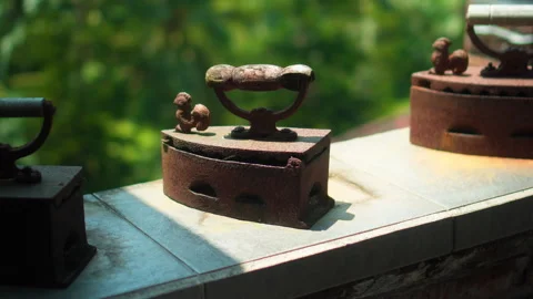 Antique rusty charcoal iron for ironing clothes with wooden handle stands o.. Stock Footage 304472986