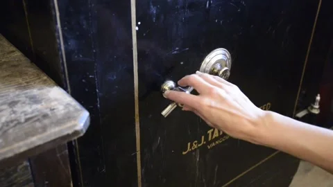 Antique safe -Woman's hand opens and removes book/diary and opens it Stock Footage 152589089