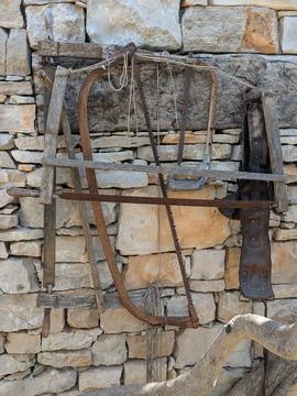 Antique saws and tools on an old stone wall in Croatia Stock Photos