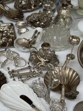 Antique silverware collection on display with various ornate cutlery and dish Stock Photos