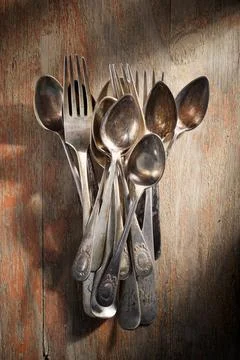 Antique silverware on a wooden table Stock Photos