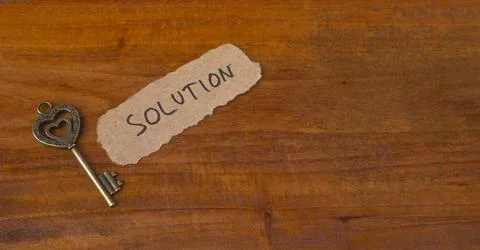 Antique Skeleton Key with Solution Label on Rustic Wooden Background Flat Lay Stock Photos