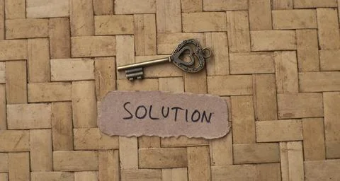 Antique Skeleton Key with Solution Paper Label on Woven Bamboo Background Stock Photos
