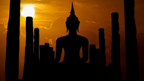 Antique Statue of Buddah at Sunset in Time Lapse with Sun Red Clouds, Thailand Stock Footage 101677175