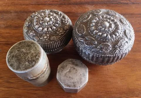 Antique Thai Silver Containers on Rustic Wooden Background Stock Photos